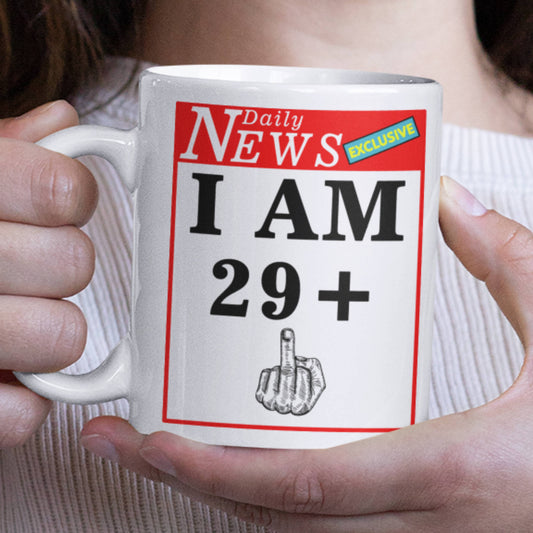 Person holding a mug with a humorous design featuring a newspaper headline and middle finger gesture.