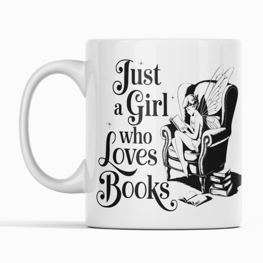 White mug. Black Print. Girl with wings in an armchair. Text Just a girl who loves books