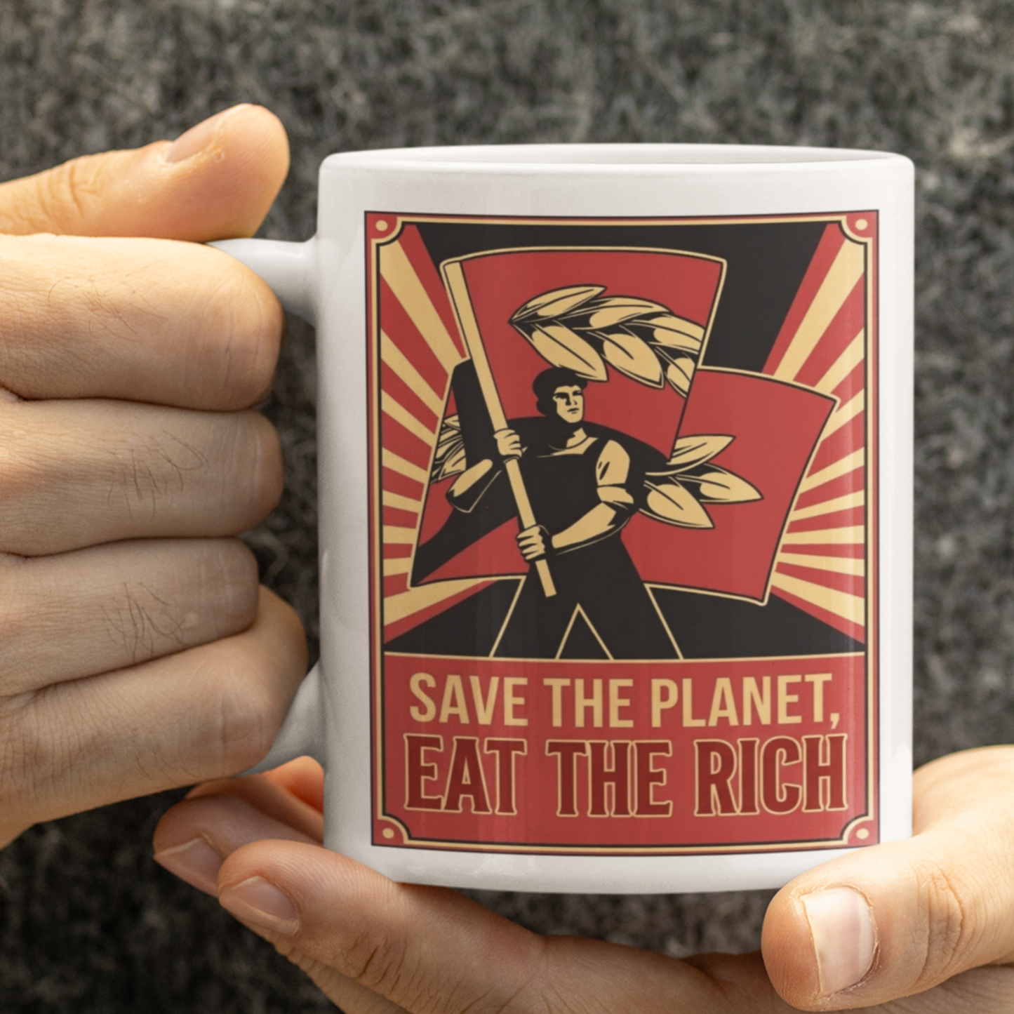 Mug with graphic design and text 'Save the Planet, Eat the Rich'  and a staff held by a person.