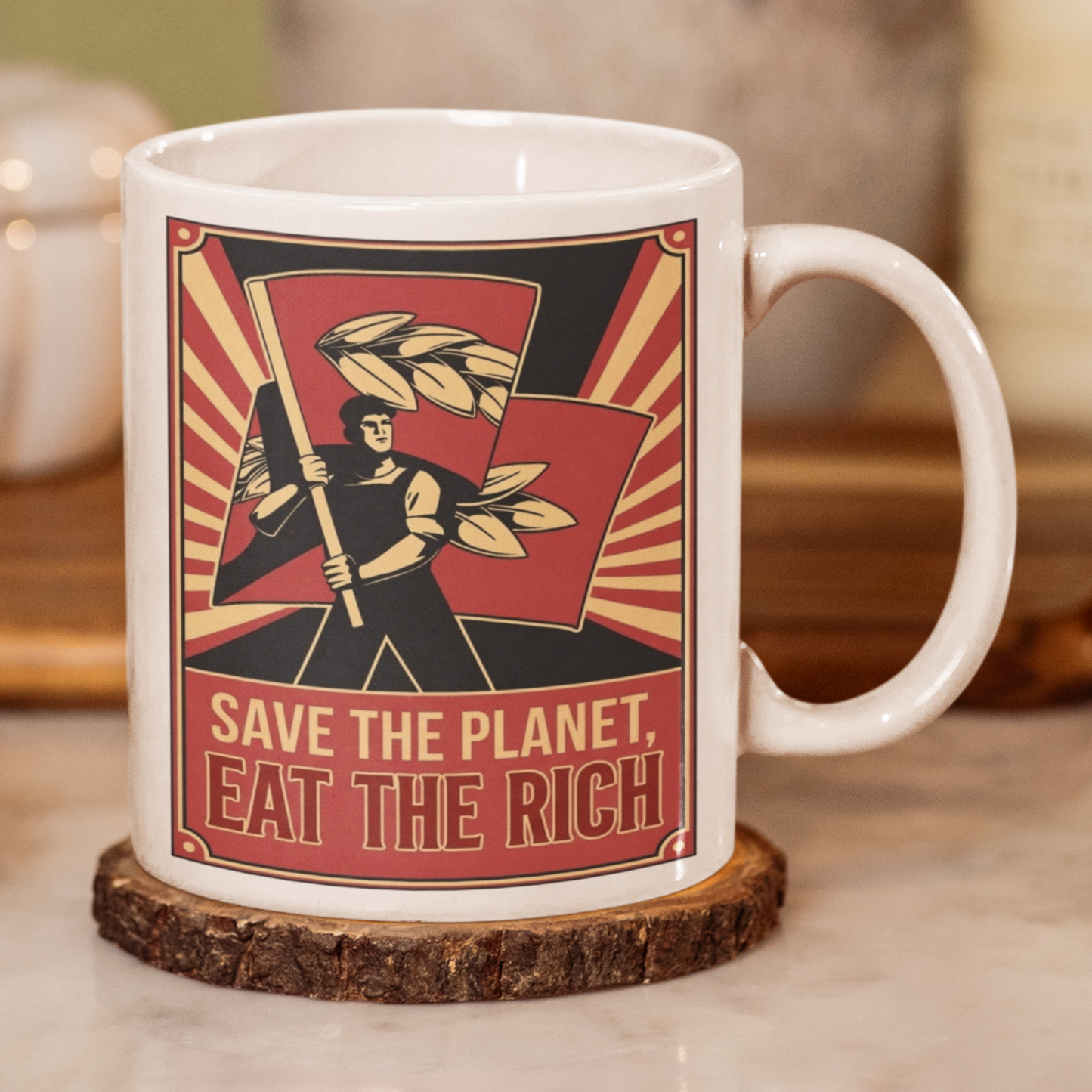 Mug with graphic design and text 'Save the Planet, Eat the Rich' on a wooden coaster.