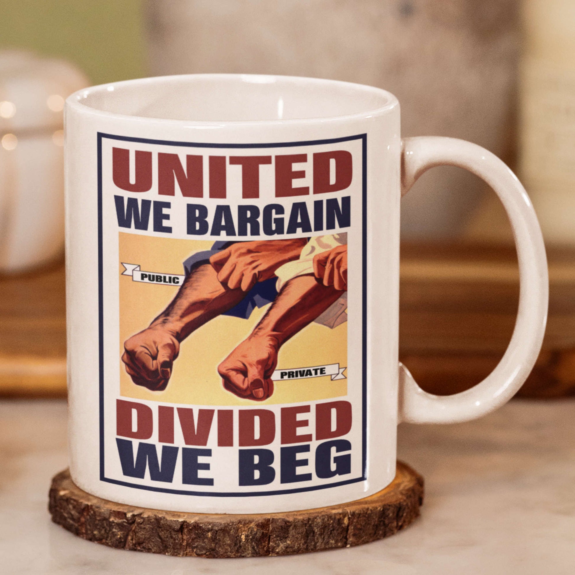 Mug with graphic design featuring text 'United We Bargain, Divided We Beg' on a wooden coaster.